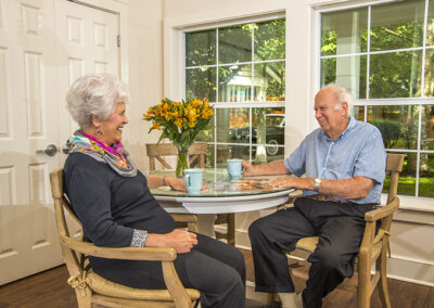 Couple seated together at a great-room table